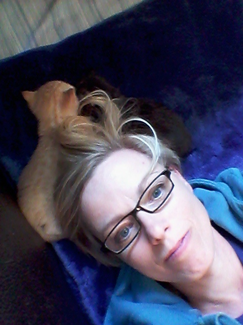 Kristene Perron on a pillow with kittens