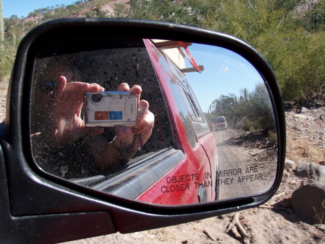 Camera shot into side mirror of truck